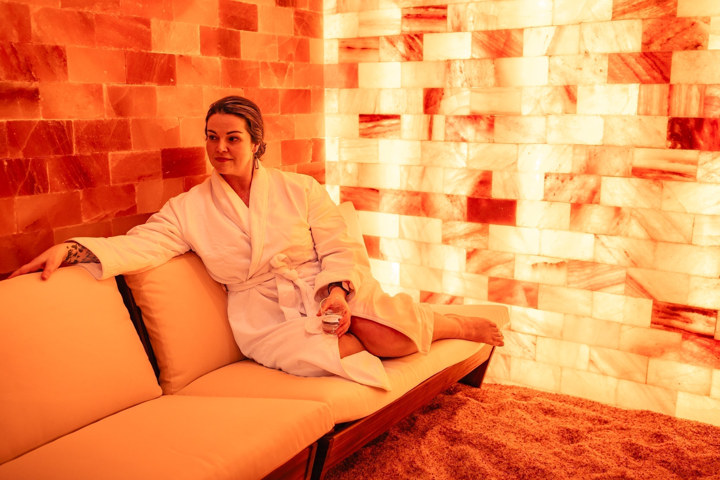 A woman experiences halotherapy in a salt vault in a luxurious spa.
