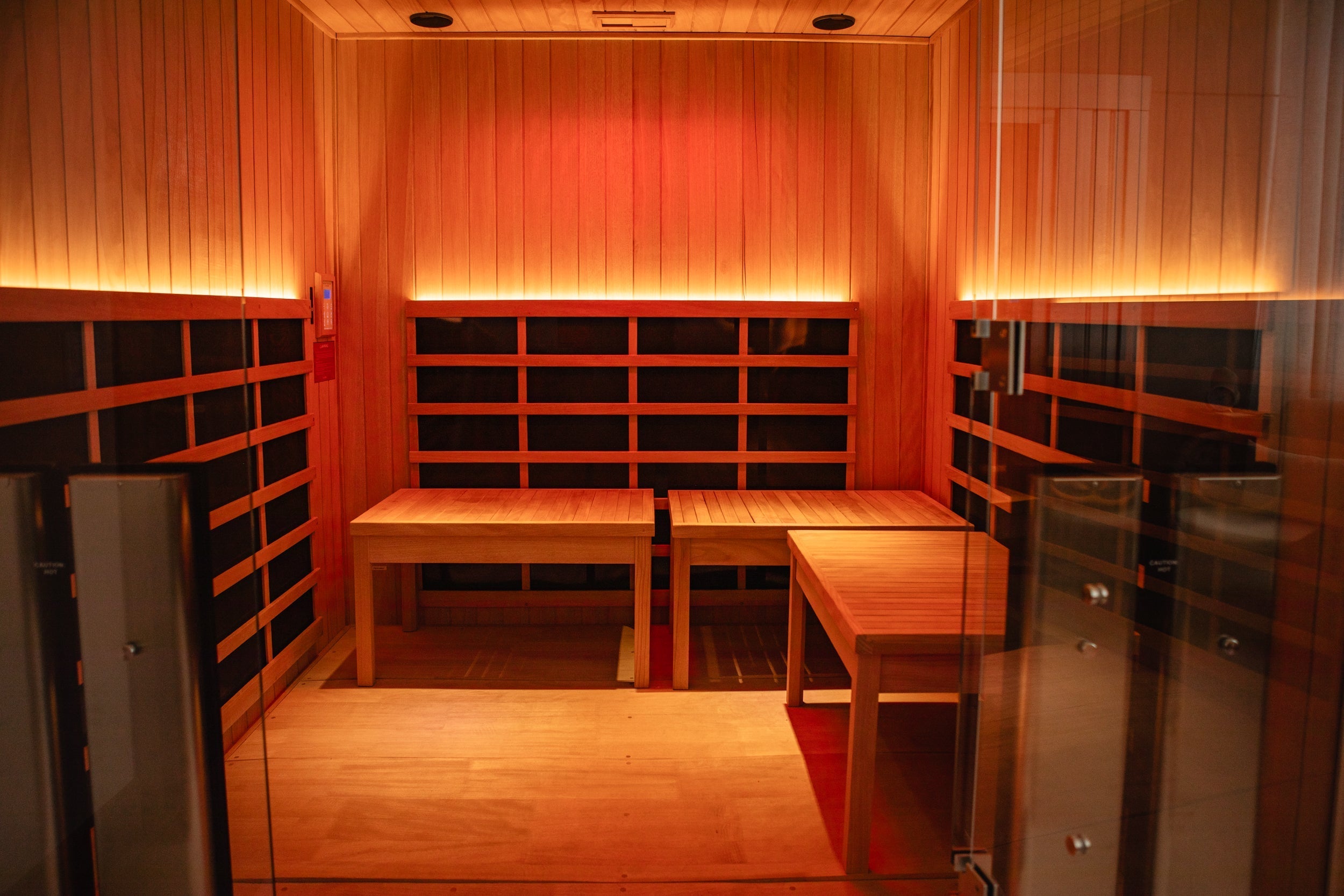 An inviting wood panel sauna is heated by infrared light.
