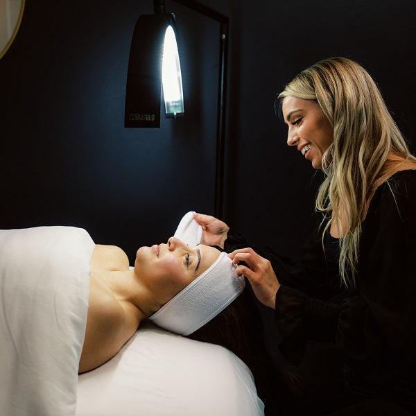 An esthetician prepares a guest to receive a BioRePeel facial treatment in a luxury medspa.