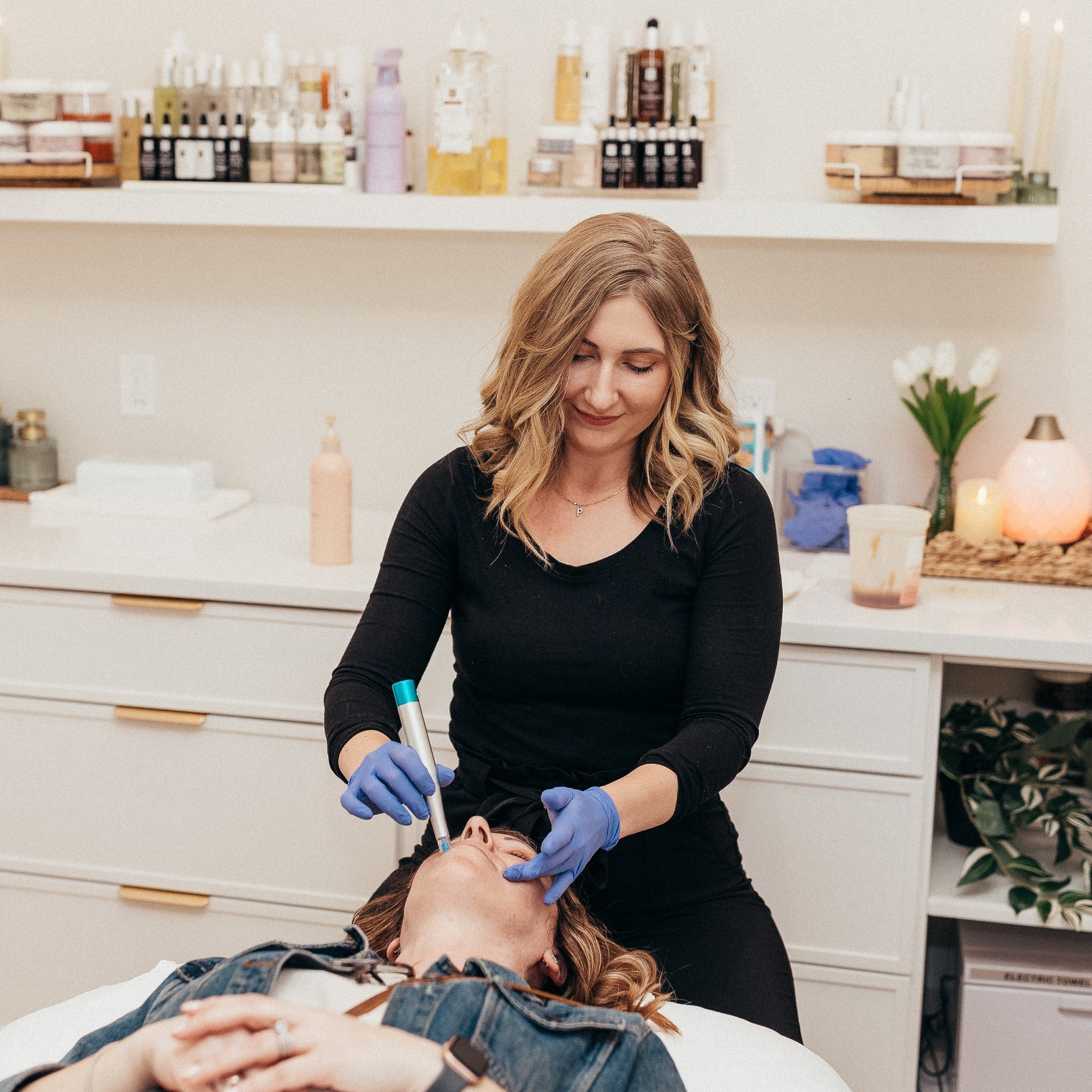 A woman receives a nano needling treatment in a luxury spa.