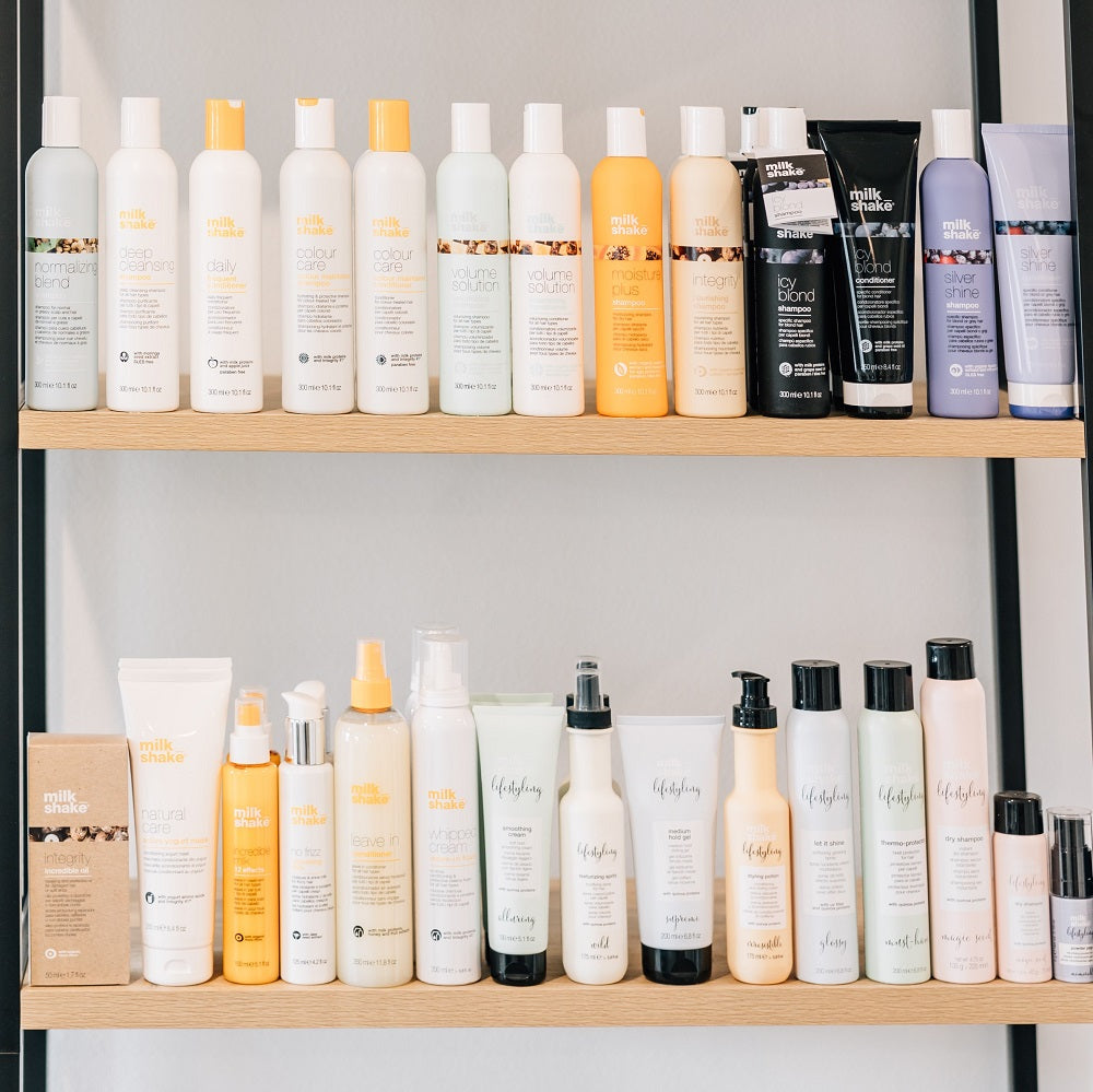 A shelf features salon-grade hair products from multiple professional hair care brands.