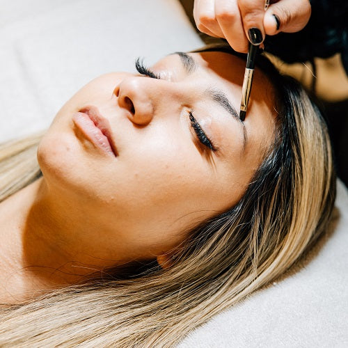 A guest relaxes while receiving a brow tint treatment at Pure Skin Wellness Spa in Mount Vernon