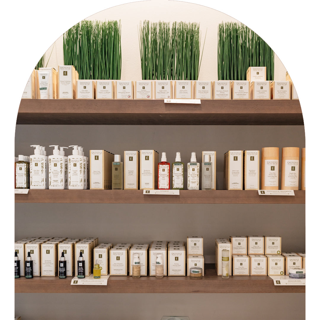 A spa boutique features multiple shelves of Eminence Organics skincare products including multiple tester samples. 