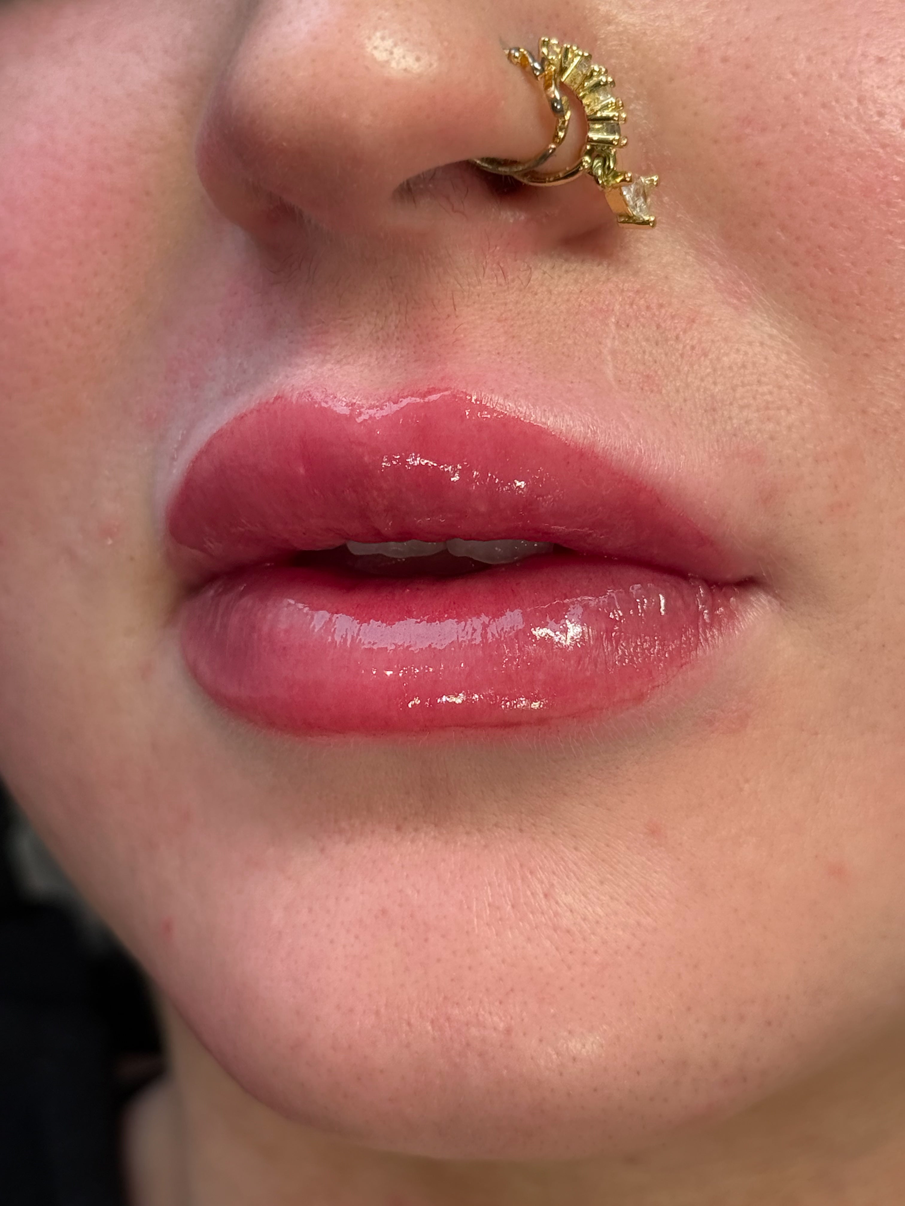A close up of a woman's lips after receiving a lip blush treatment for permanent makeup