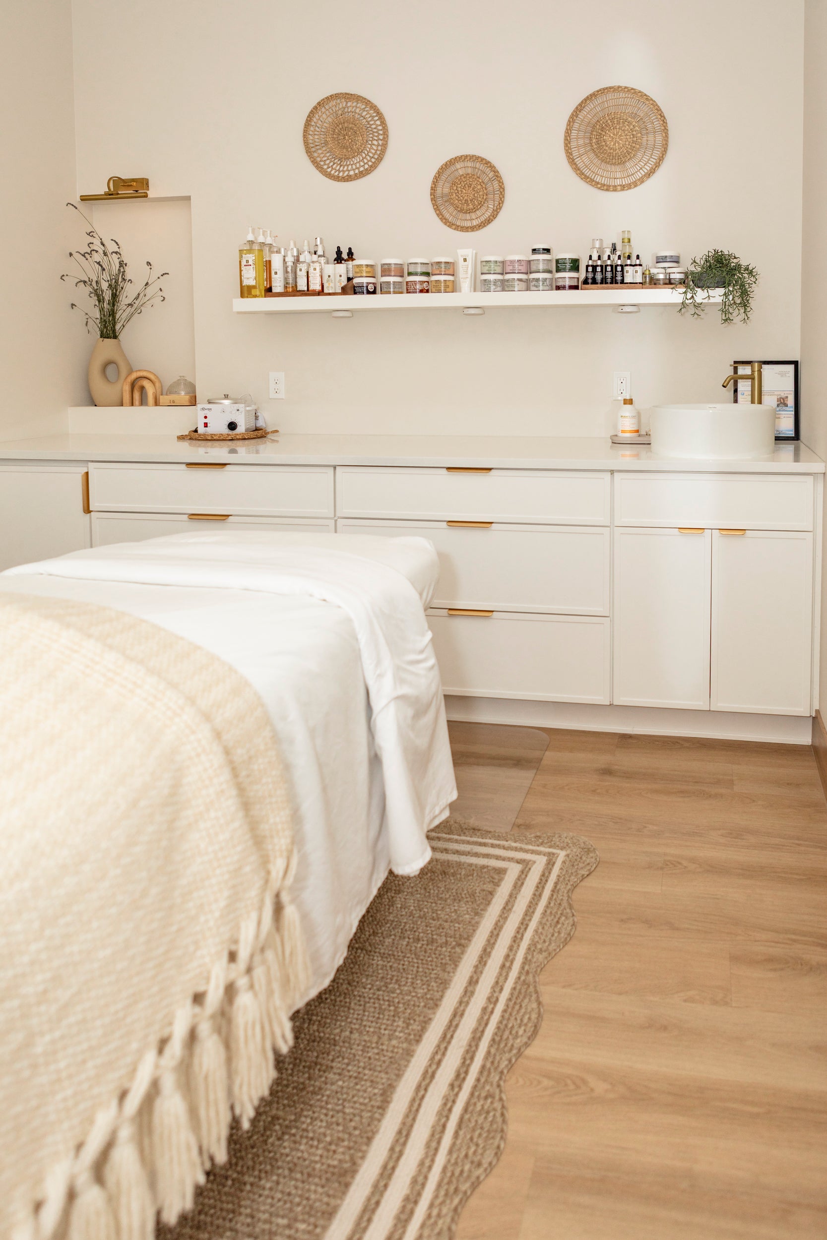 A calming and serene treatment room in a luxury spa features Eminence Organics products.