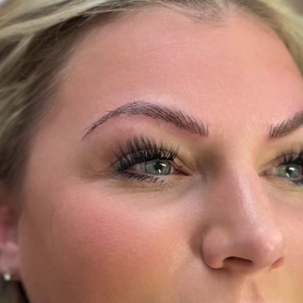 A close up image of a woman's eye shows the dramatic results of a microblading eyebrow treatment at Pure Skin Wellness Spa
